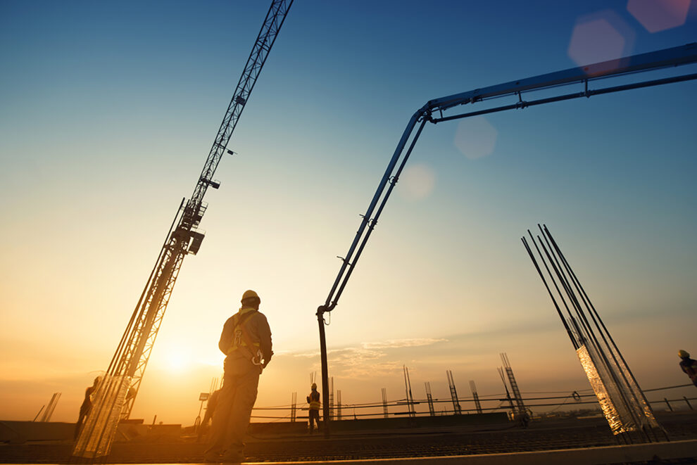 Construction worker Concrete pouring during commercial concretin Concrete Pump